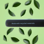 Phone case close up with 'Made with recycled materials' text on a green background with leaves